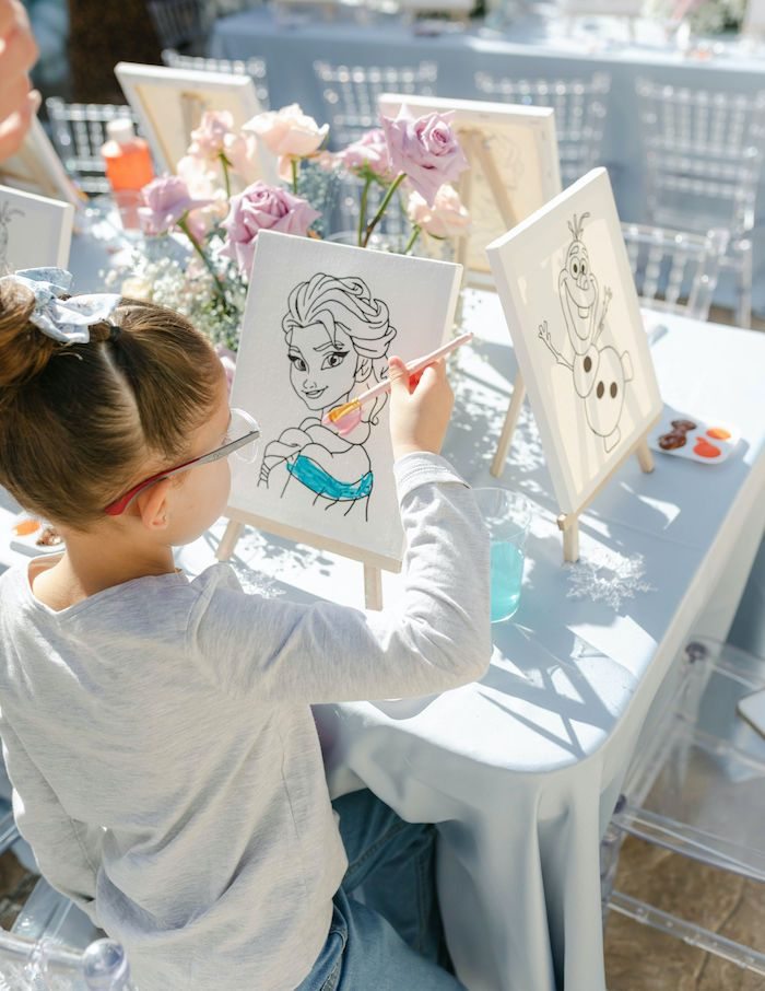 A child painting at a birthday party activity table